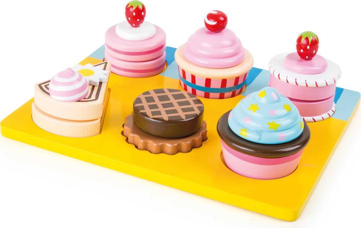 small foot Cutting cupcakes and cakes