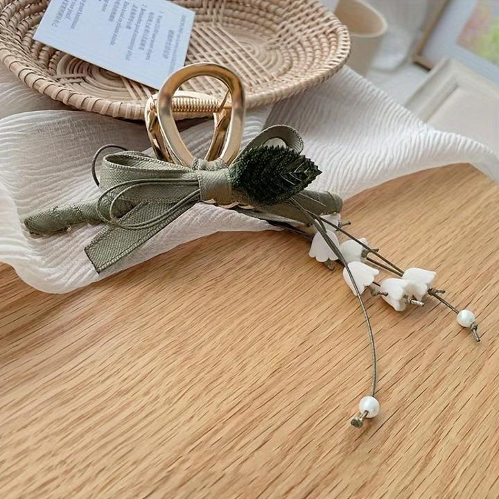 Produktbild Activity Board 1 Stück Elegante französische Maiglöckchen-Haarspange mit Quaste ist eine schicke Spange (1 Stk.)