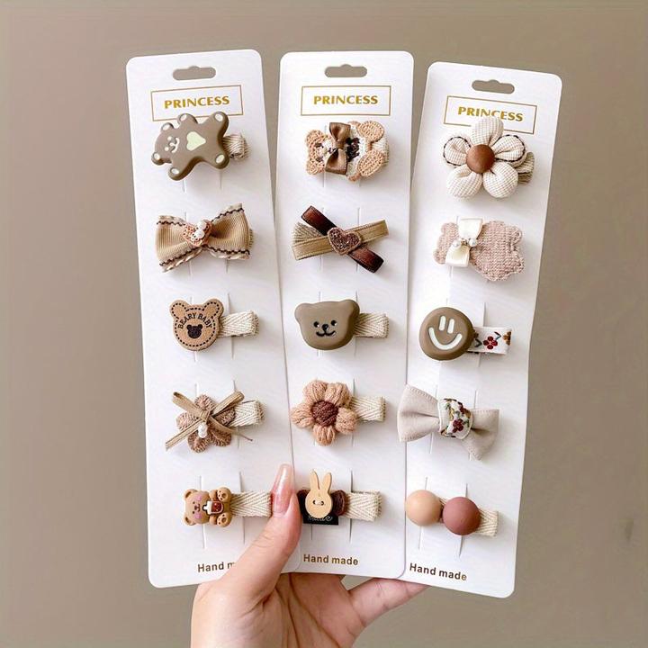 Image du produit Activity Board 15/20pcs pinces à cheveux en forme d'animaux de dessins animés avec un visage souriant et un noeud (1 pcs)