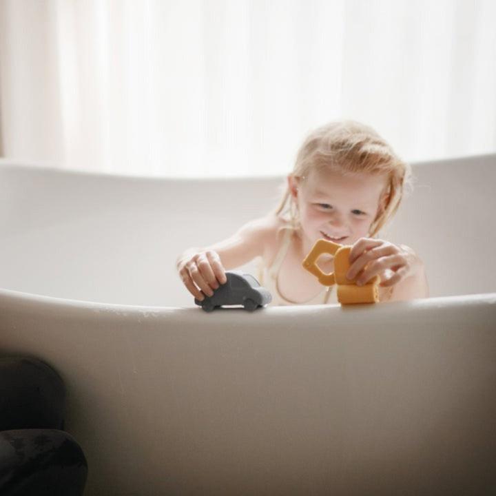 Actual product image Mushie Bath play set vehicles