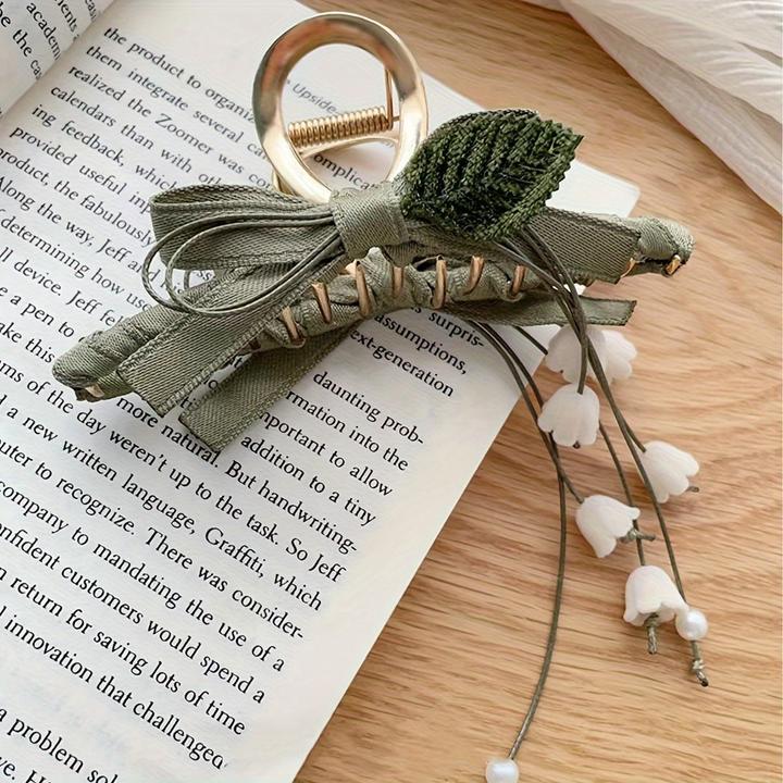 Produktbild Activity Board 1 Stück Elegante französische Maiglöckchen-Haarspange mit Quaste ist eine schicke Spange (1 Stk.)